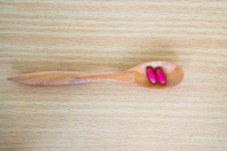 diferent Tablets pills capsule heap mix therapy drugs in spoon.の写真素材