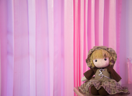 doll on pink soft background.の写真素材