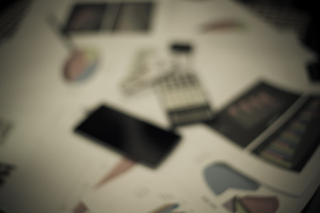 Blurred business work space in dark tone.