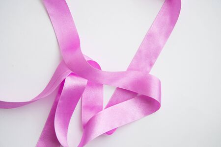 Pink ribbon on a white backgroundの写真素材