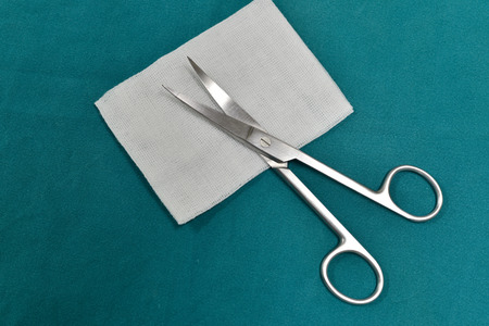 surgical instruments and tools including scalpels, forceps and tweezers arranged on a table for a...