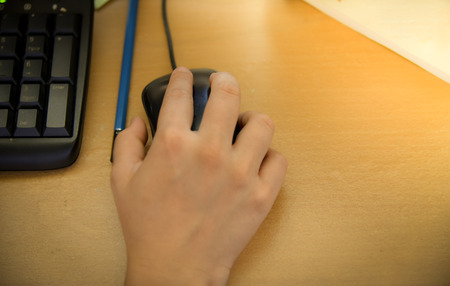Close-up of hand on mouseの写真素材