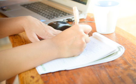hands with pen writing on notebookの写真素材