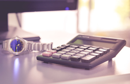 blurred watch and the calculator in manangement time concept.の写真素材