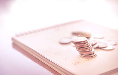 Blurred calendar page pink tone in Saving money concept.
