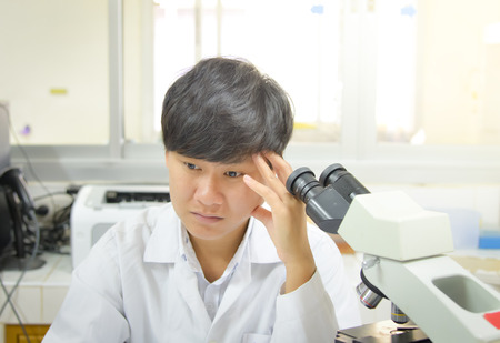 asia scientist working in biological laboratory.