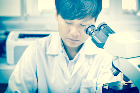 asia scientist working in biological laboratory.の写真素材