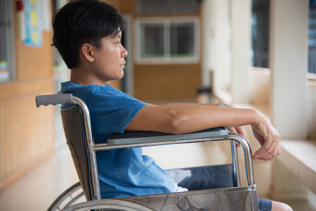 patient in wheelchair parked in hospital with selective focus.