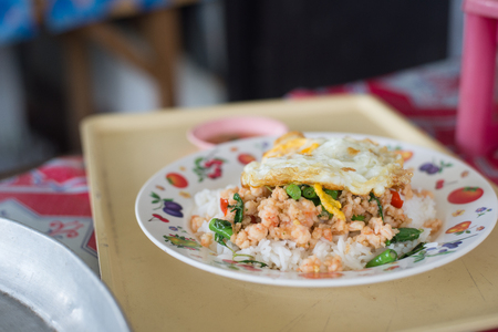 Rice topped with stir fried minced pork and basilの写真素材