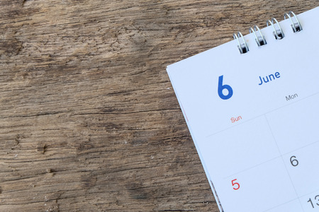 Blurred calendar page on wood texture.の写真素材