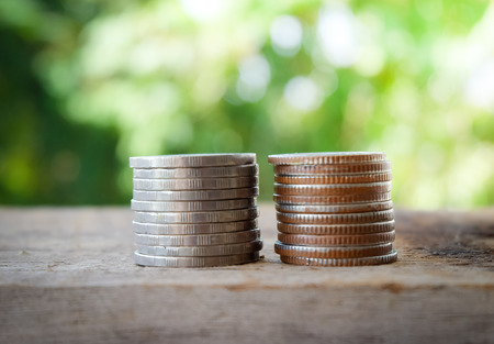 Savings Coins on green nature background.