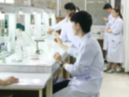 Blurred scientis student learning in classroomの写真素材