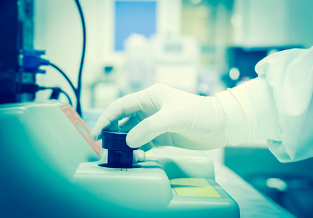 Blurred hand scientist working in blue toneの写真素材