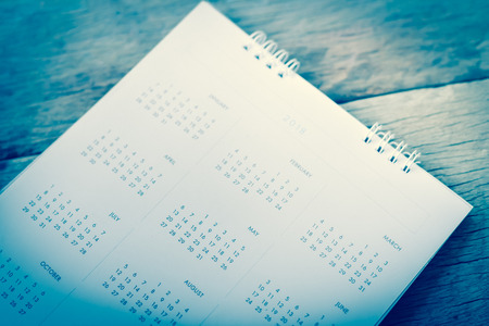Blurred calendar on wood texture.blue tone.の写真素材