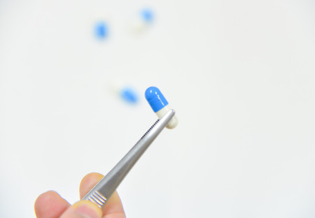 Blue pills on whiteの写真素材