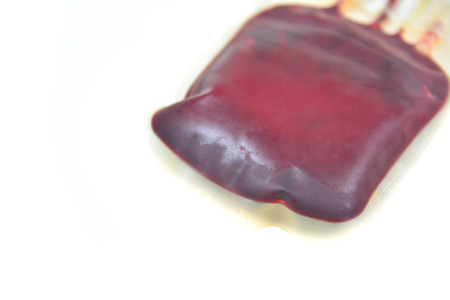Red blood bag on white in laboratory.の写真素材