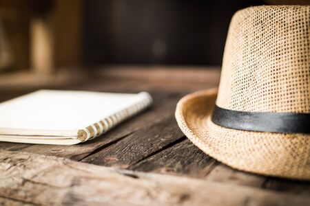 Notebook with hat in writing concept.の写真素材
