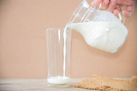 Milk bottle and milk glass on wooden table. Healthy eating conceptの写真素材