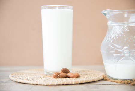 Milk bottle and milk glass on wooden table. Healthy eating conceptの写真素材