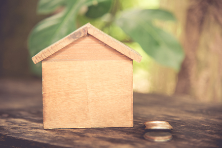 Wooden house model on green nature background.の写真素材