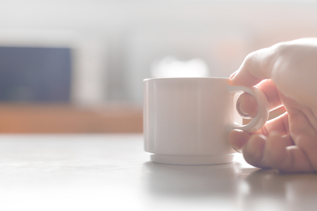 Blurred White cup coffee on white tone.の写真素材
