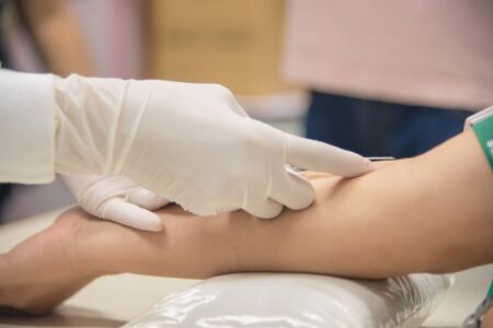Closup on hand scientist working with patient.