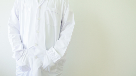 scientist in white coat on white wall.の写真素材