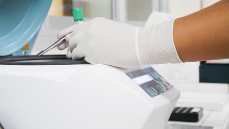 Hand scientist working in laboratory using with centrifuge.