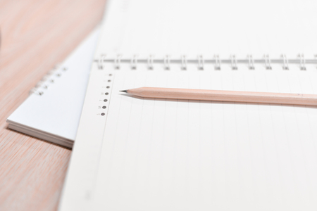 Blur pencil and notebook diary concept in white tone.の写真素材
