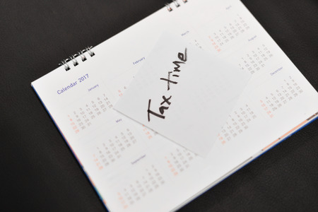 Tax time on white paper.の写真素材