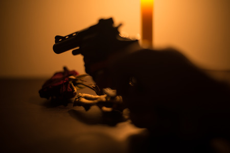 close up gun in dark tone lovesick concept.