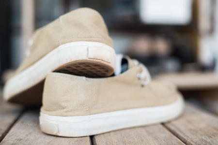 close up sneakers on wood texture.の写真素材