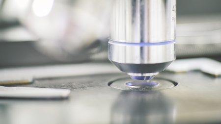 Close up objective lens microscope in laboratory.