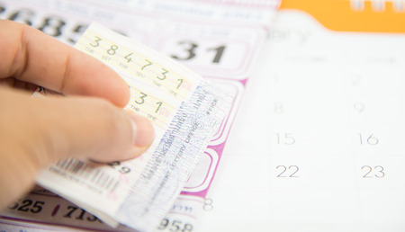 Checking thai lottery in jackpot on white background.の写真素材