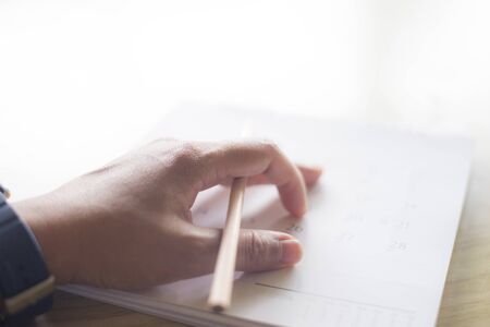 close up hand writing in calendar plan concept.の写真素材