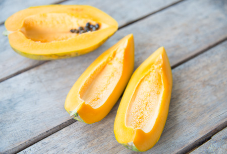 Close up Yellow papaya fruit on wood table.