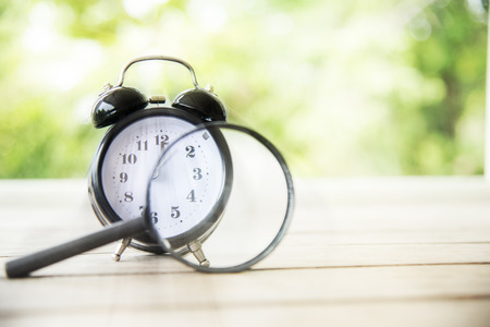 Close up Vintage clock on wood table.