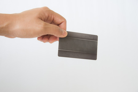 Hand holding business black card on white background.の写真素材