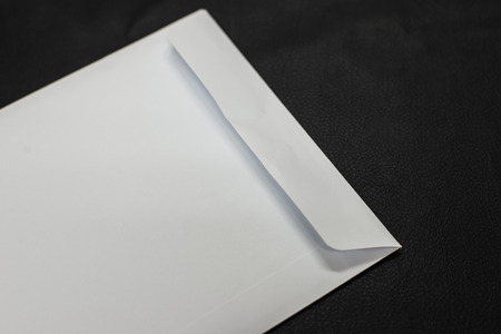 Close up white envelope on black background.の写真素材