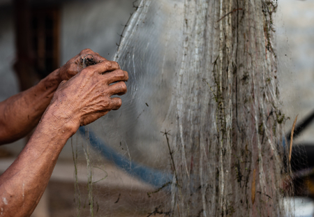 Close up old hand fisherman and hard work.の写真素材