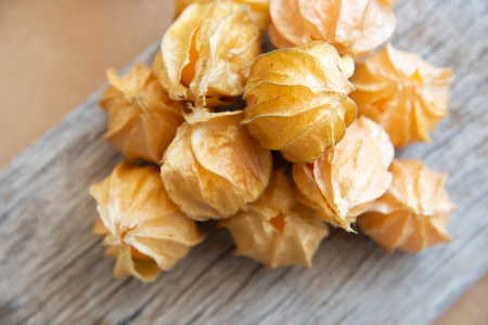 Yellow cape gooseberry fruit on wood texture.look like egg.の写真素材