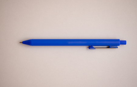 Close up blue pen with white papper.の写真素材