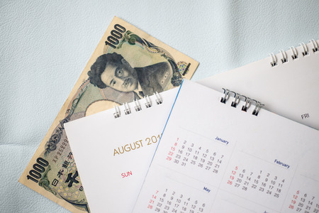Close up Japan banknote with calendar in travel planning concept.の写真素材