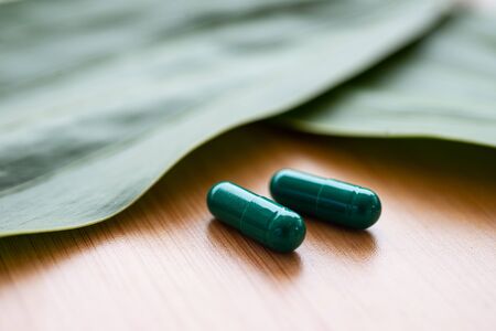 Close up Green pills on herb concept.の写真素材
