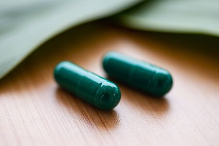 Close up Green pills on herb concept.の写真素材