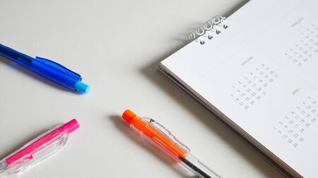 Close up White calendar with pen on white background.の写真素材