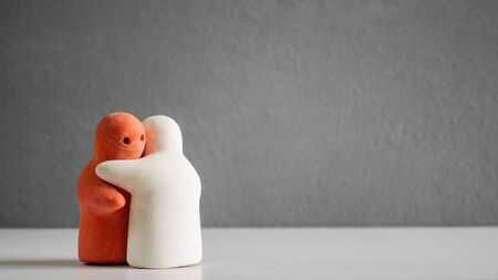 Toy hug in love concept on grey background.の写真素材