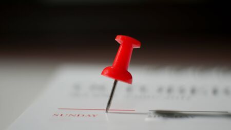 Close  up red pin marked on calendar in planning concept.の写真素材