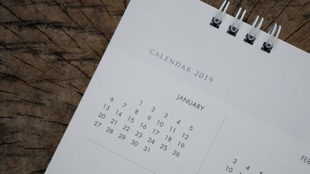 Close up calendar on wood table in planning concept.の写真素材