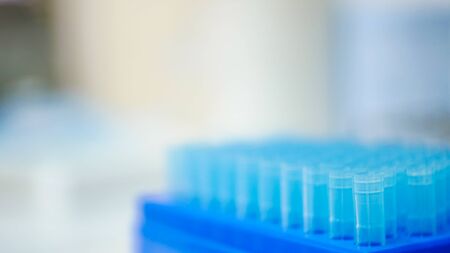 Blurred Blue pipette tip in blue box.